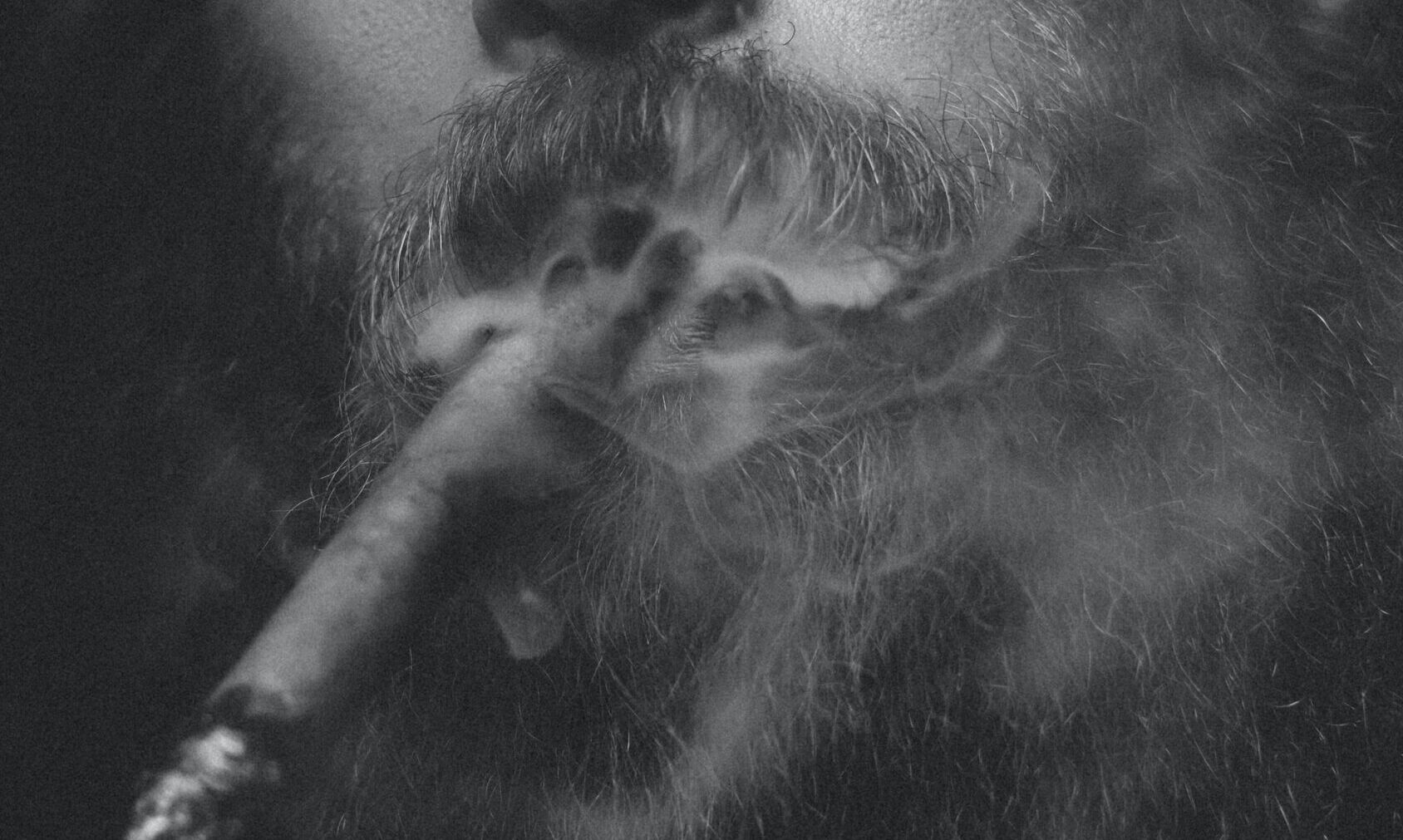 picture of a bearded man, smoking